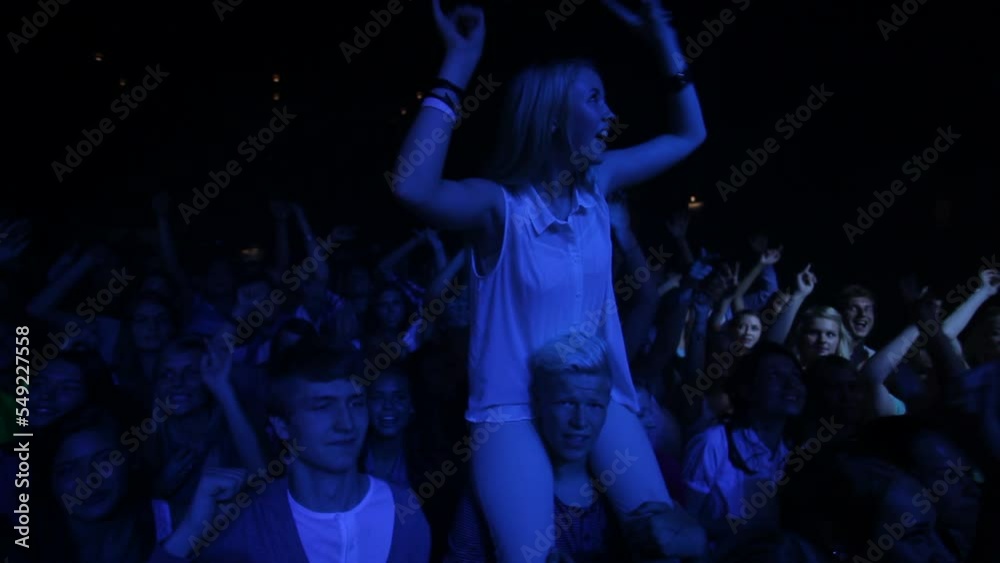 Dance, night and crowd at a party, concert or music festival celebration for young happy people dancing at rave. Disco, friends or crazy audience celebrate youth or freedom at nightclub social event