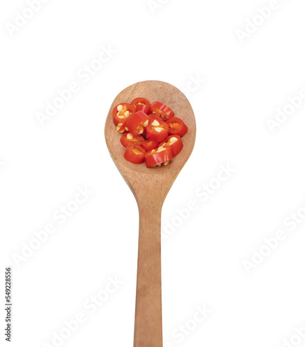 Chili. Wooden spoons full of sliced sliced paprika fresh. Bright red with brown wooden spoon. It has a hot and spicy flavor suitable for cooking.	