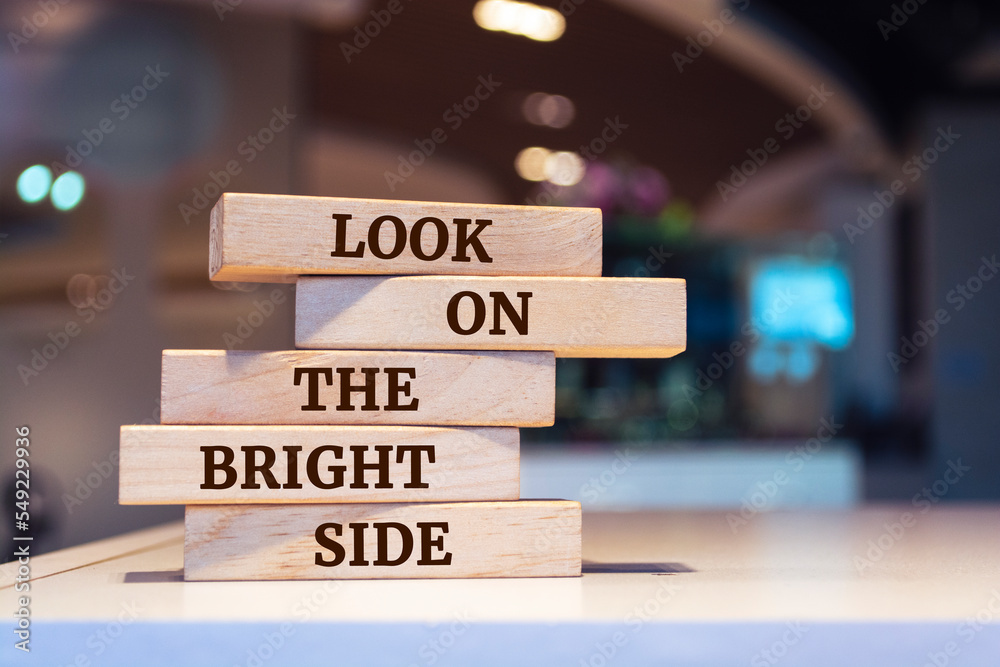 Wooden blocks with words 'Look on the bright side'.