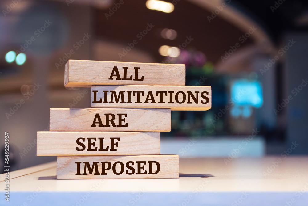 Wooden blocks with words 'All limitations are self imposed'.