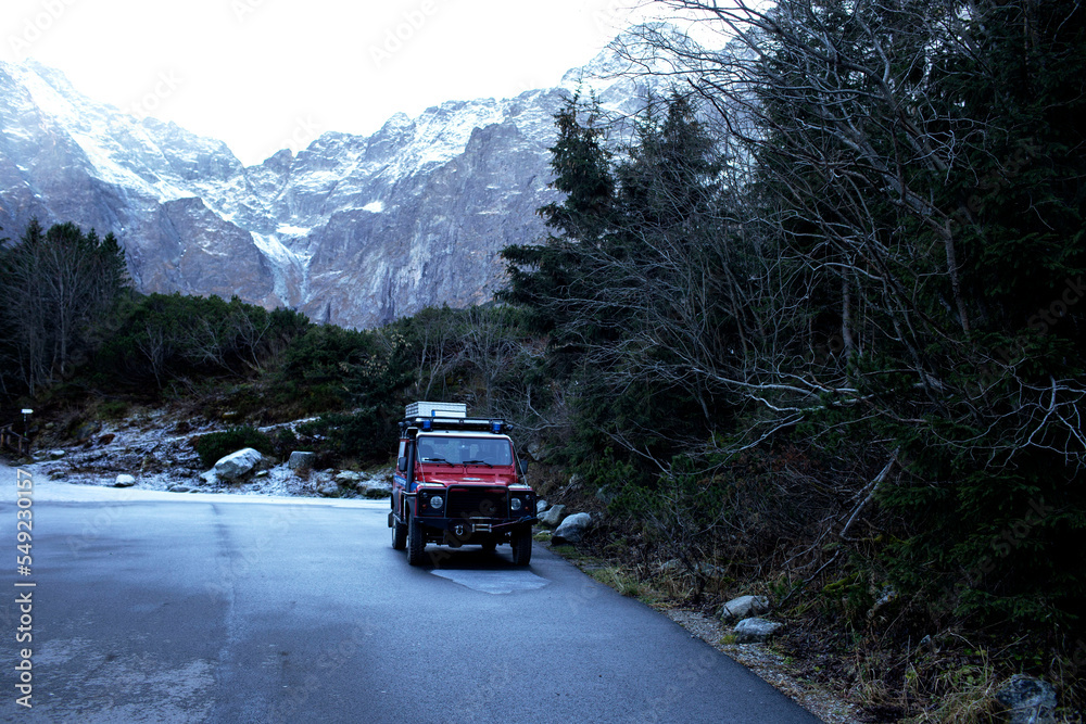 Tatras. Red car jeep on the background of mountains. Beautiful place. Tatra National Park Poland. Famous tourist place in the Tatras. Tatras. Red car jeep on the background of mountains. Beautiful place. Tatra National Park Poland. Famous tourist place in the Tatras.