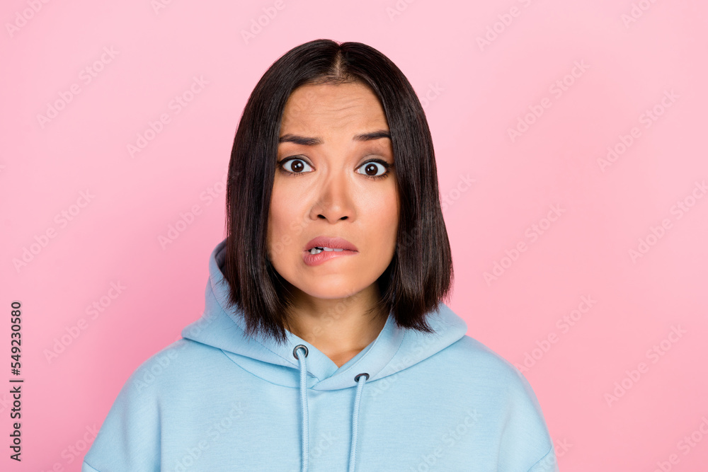 Photo portrait of attractive young girl bite lips confused unsure problem dressed stylish blue outfit isolated on pink color background Photo portrait of attractive young girl bite lips confused unsure problem dressed stylish blue outfit isolated on pink color background