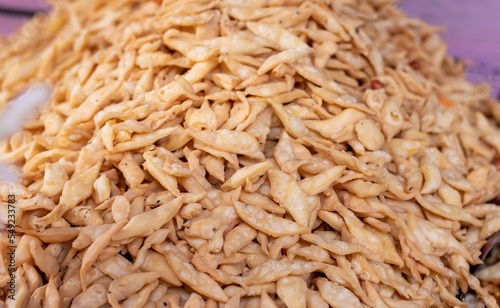 Closeup of Nimki or Salted Namak Para Indian Crunchy Savoury Snack Heap with Selective Focuc on Front photo