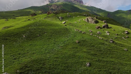 Aerial view of the mountainside and beautiful alpine green meadows