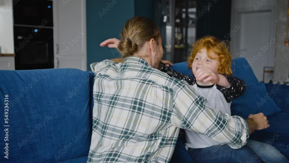 Young father and little son give high five and hug tenderly Young father and little son give high five and hug tenderly