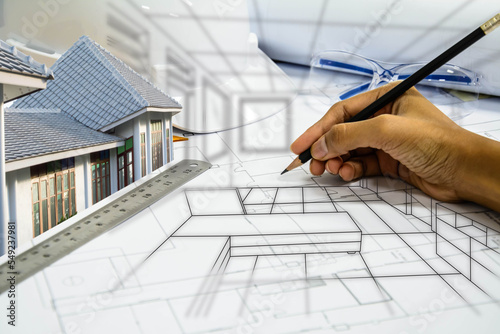 Design drawings and hands drawing a project by pencil on paper