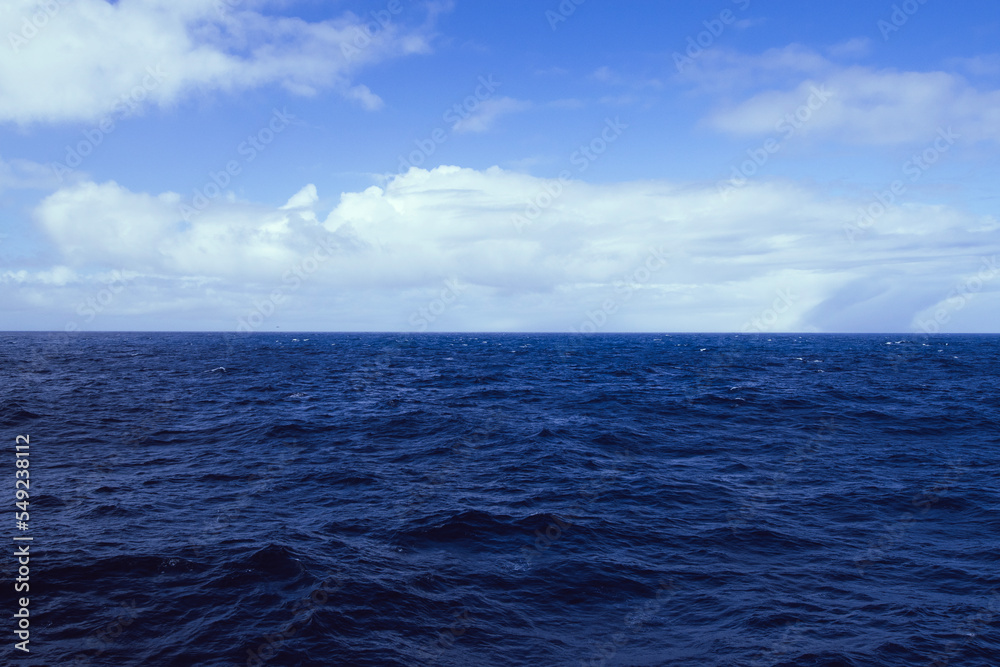 Fototapeta premium The blue sky and ocean meet in the Drake Passage.
