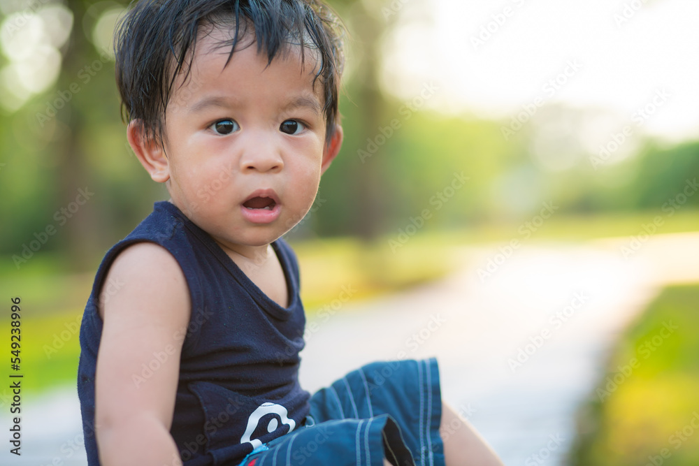 Toddler asian boy playing outdoor park sunset light