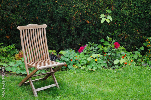 Vintage wooden chair in green country garden