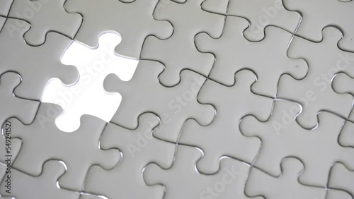 Hand holding jigsaw puzzle last missing piece lighting. 
Concept last piece of jigsaw puzzle for problem and 
completion.