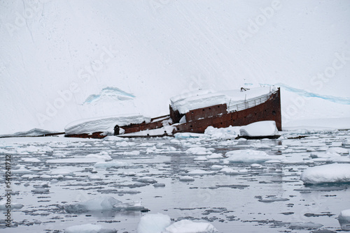 A sunken metal whaling boat, Gouvernoren, is trapped in the Ice of Antarctica Enterprise Island.  photo