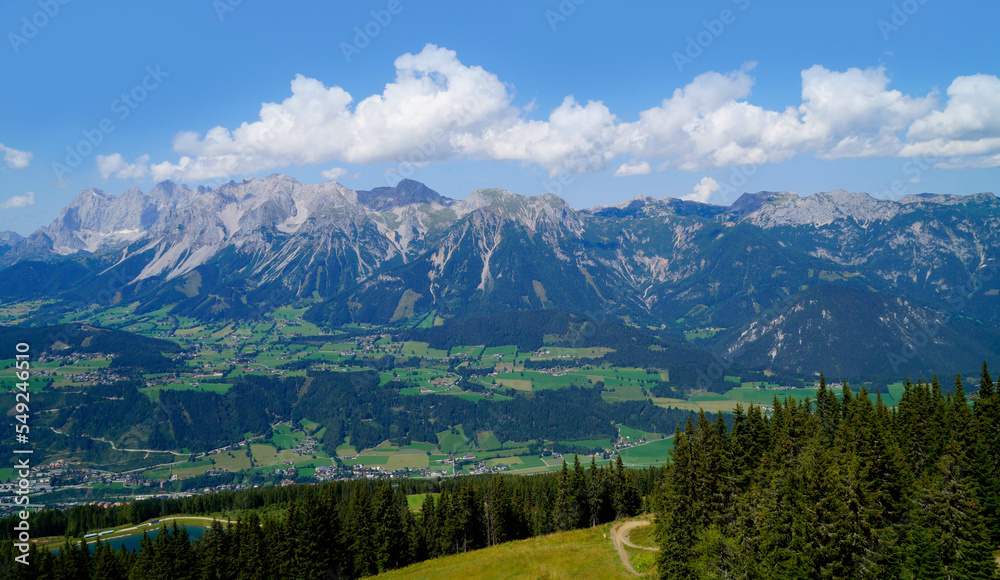 a hiking trail overlooking the beautiful alpine landscape with vast green alpine valley in the Austrian Alps of the Schladming-Dachstein region (Steiermark, Austria)	
