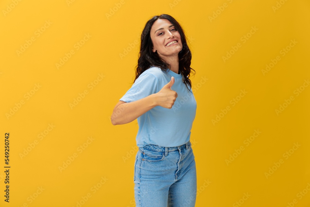 Woman signal smile with teeth emotion portrait in blue t-shirt on yellow background, hands up, surprise, lifestyle, copy space
