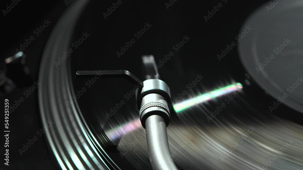 Turntables tonearm with spherical needle plays record with music. Retro DJ turn table player device playing vinyl disc Turntables tonearm with spherical needle plays record with music. Retro DJ turn table player device playing vinyl disc