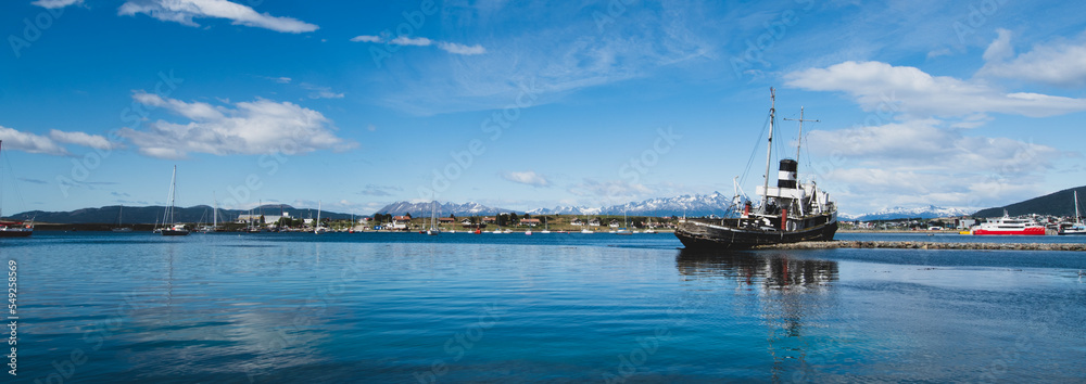 St. Christopher (formerly HMS Justice)  shipwreck with the Ushuaia harbor and Andres Mountains in the background. WWII ear ship now stands as a monument to all ships lost in the region. 