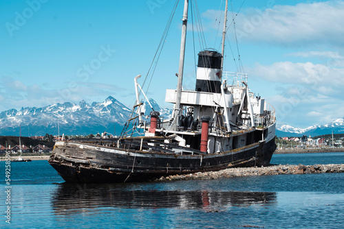 St. Christopher (formerly HMS Justice) shipwreck with the Ushuaia harbor and Andres Mountains in the background. WWII ear ship now stands as a monument to all ships lost in the region. 