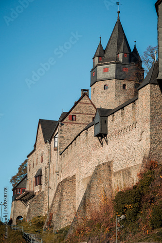 Altena Castle “Burg Altena“ in Sauerland Germany is a famous Landmark monument in the Lenne Valley and Mediaval Sight with First Youth Hostel of the World on a sunny colorful autumn day photo