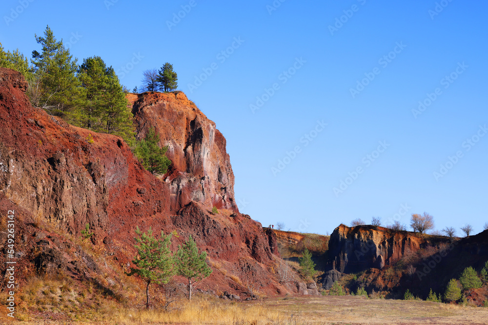 Beautiful landscape of the remains of an old sleeping volcano crater with red clay and vibrant colors, Racos, Brasov County, Transylvania, Romania