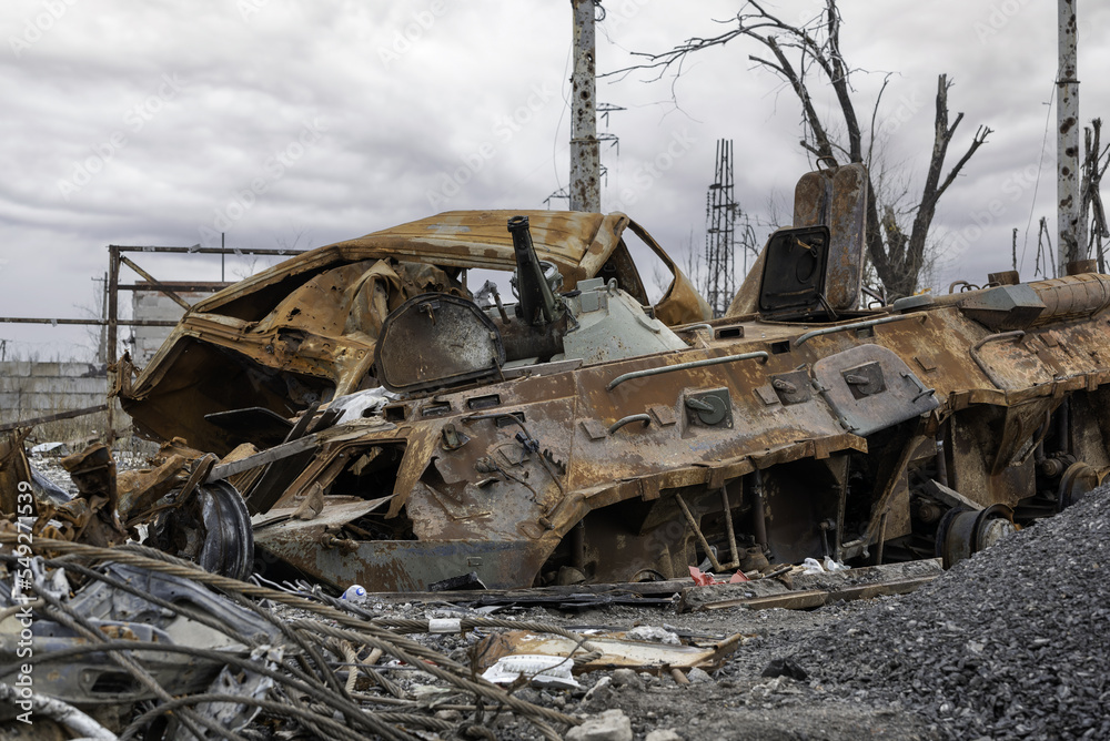 Fototapeta premium burnt tank and destroyed buildings of the Azovstal plant shop in Mariupol
