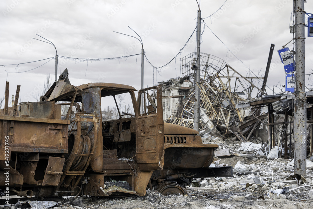 Fototapeta premium burnt cars and destroyed buildings of the workshop of the Azovstal plant in Mariupol