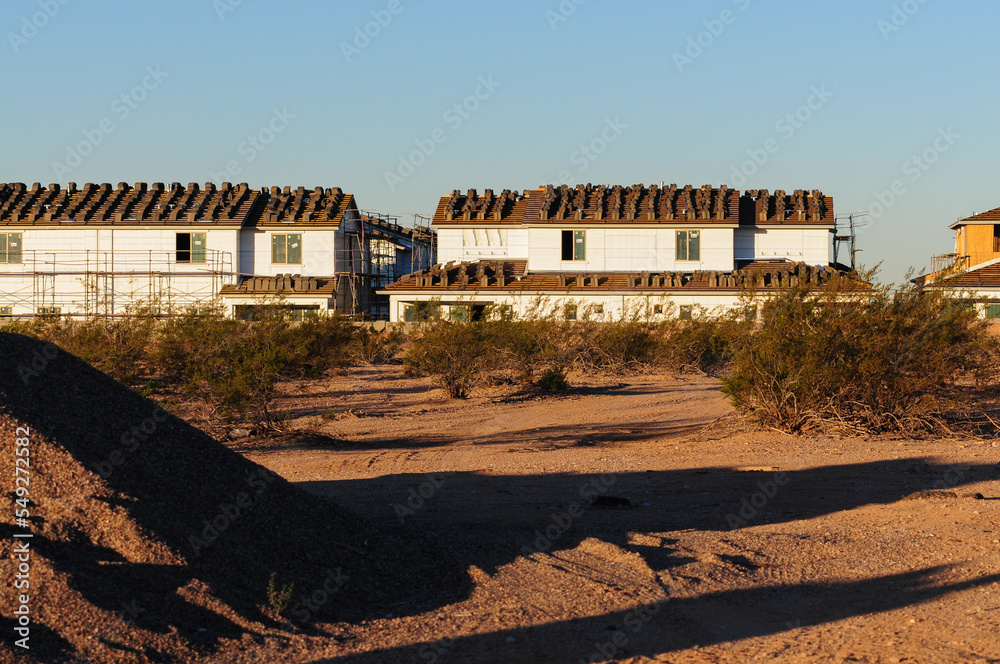 The construction site of two-story homes is visible from the vacant land, where a pile of dirt sits The construction site of two-story homes is visible from the vacant land, where a pile of dirt sits
