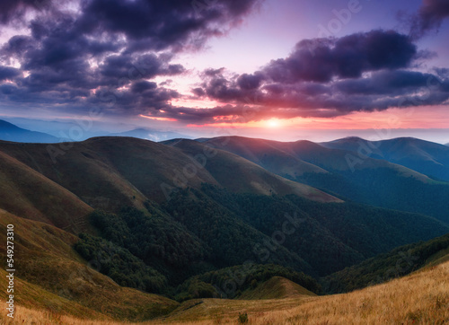 Panoramic view of colorful sunrise in mountains. Concept of the awakening wildlife, romance, emotional experience in your soul, joy in mundane life. 