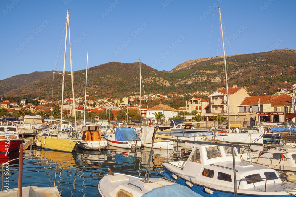 Beautiful winter Mediterranean landscape. Fishing boats in harbor. Montenegro, Tivat city, view of Marina Kalimanj