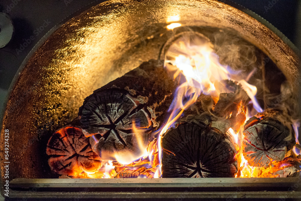Burning firewood in fire-box of boiler in country cottage. Burning firewood in fire-box of boiler in country cottage.