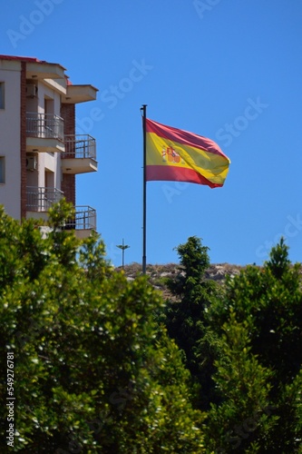 Bandera española ondeando al viento photo