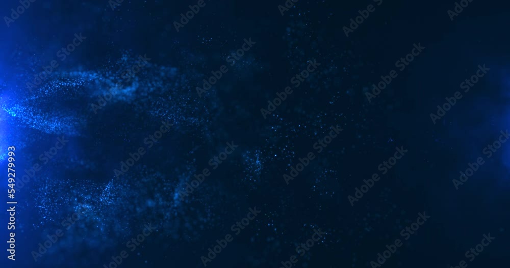 A vortex of blue particles slowly unfolding against a blue background. Bokeh particles. Water vapor in blue light.