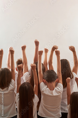 Activist kids raising hands on protest rally © Svitlana