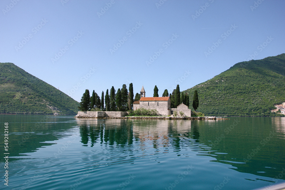 view of Our Lady on the Rocks, a church in Montenegro on an island surrounded by water