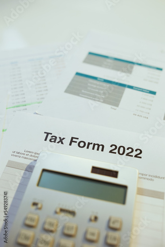tax form 2022 and calculator at desk