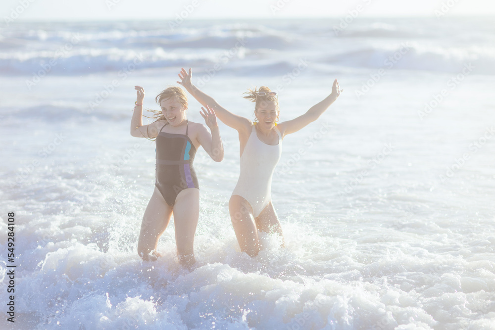 happy modern mother and child at beach having fun time happy modern mother and child at beach having fun time