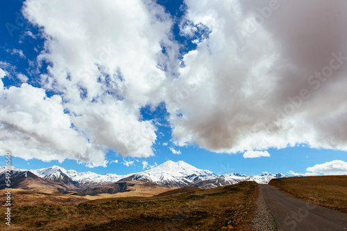 Beautiful view of Mount Elbrus with a cloudy sky and the road. Autumn mountain landscape. North Caucasus, Karachay-Cherkess Republic, Russia