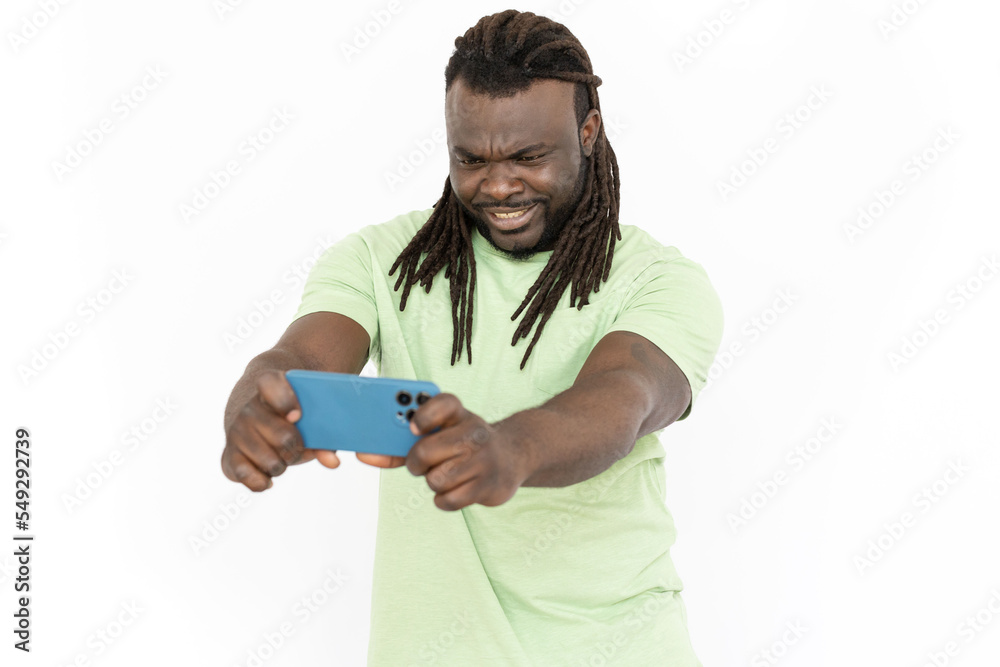 Confused African American man looking at mobile phone screen. Serious man having online video call with friend or having some problems with gadget. Communication, technology emotion concept Confused African American man looking at mobile phone screen. Serious man having online video call with friend or having some problems with gadget. Communication, technology emotion concept