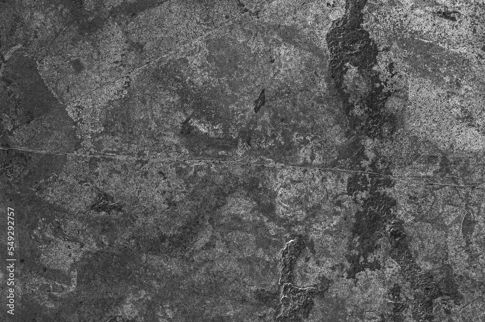 Gray stone wall with dark spots and scratches. Textured stone background of gray old stone.