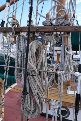 Lines hang on the side of an old sailboat in France