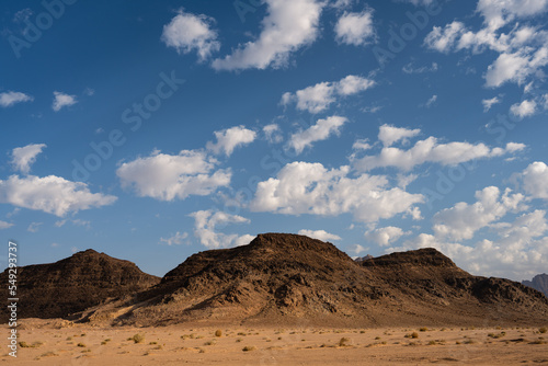 Wadi Rum Desert Landscape in Jordan with Hill and Cloudy Sky
