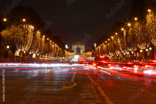 The Triumphal Arch and Champs Elysees avenue illuminated for Christmas at night ,Paris, France. © kovalenkovpetr