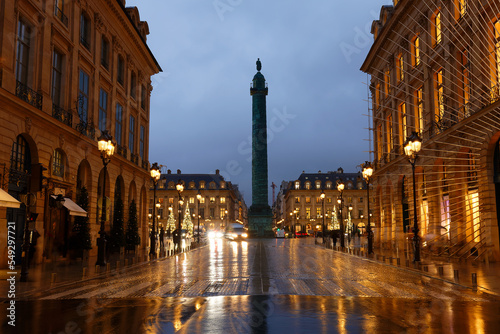 Vendome column with statue of Napoleon Bonaparte, on the Place Vendome decorated for Christmas at rainy night , Paris, France. © kovalenkovpetr