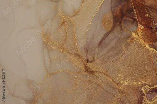 Art Abstract watercolor flow blot painting. Color canvas marble texture background. Gold, beige and brown smoke pour Alcohol ink.