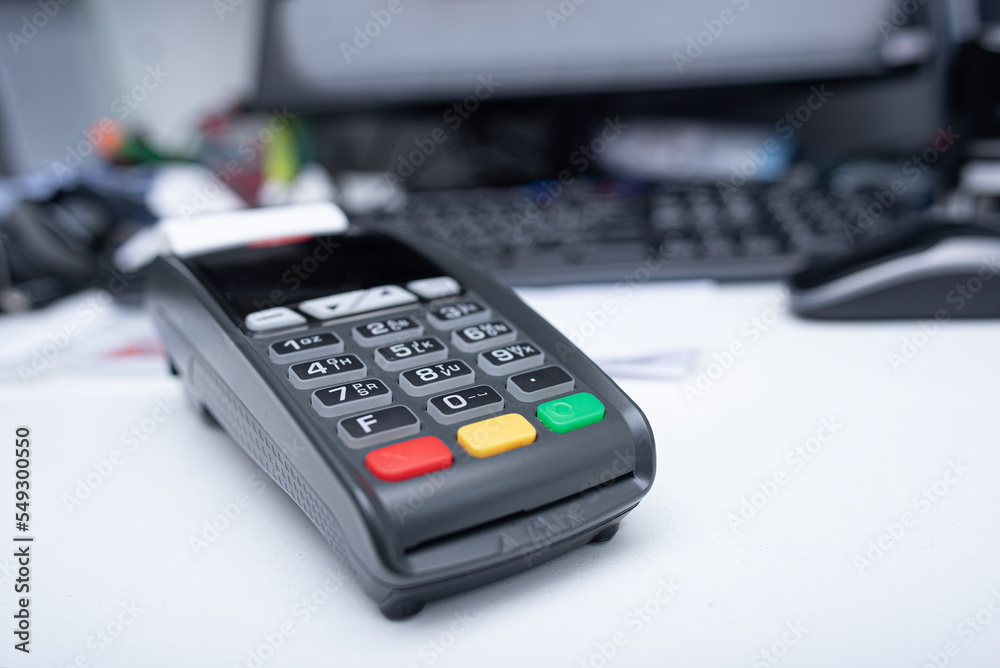 Bank terminal and payment card in the office interior. Bank terminal and payment card in the office interior.