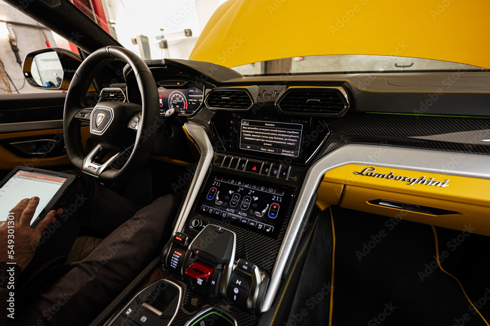 Ternopil, Ukraine- November 11, 2022: Mechanic with tablet sit inside and  test Lamborghini Urus in car service station. Stock-Foto | Adobe Stock