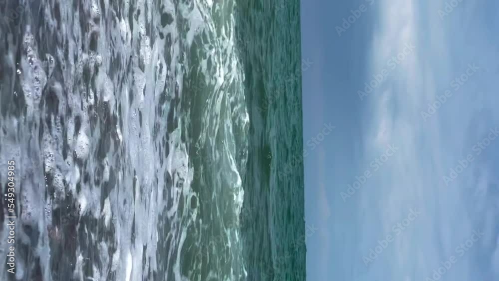 Waves of the sea on the beach with stones. Vertical video for the smartphone. Waves of the sea on the beach with stones. Vertical video for the smartphone.