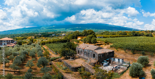 Panoramic aerial wide view of the active volcano Etna, extinct craters on the slope, traces of volcanic activity