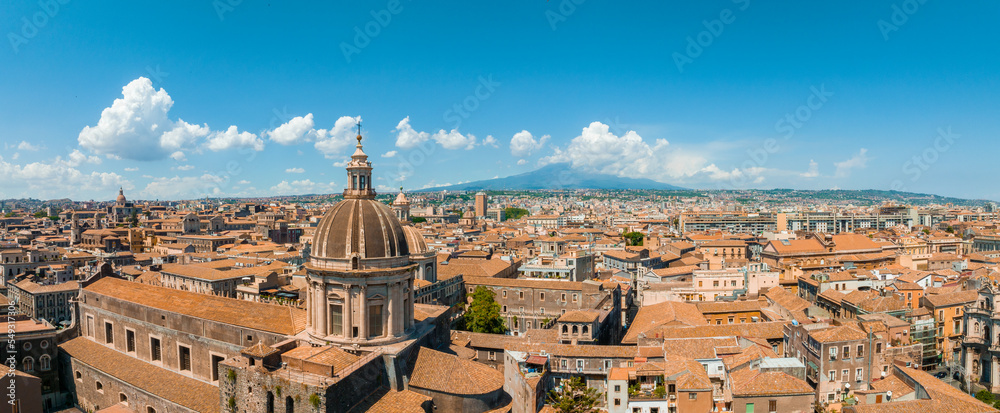 Aerial panoramic view of Catania city in Sicily, Italy. Beautiful holiday town in Italy with Etna volcano on the horizon.
