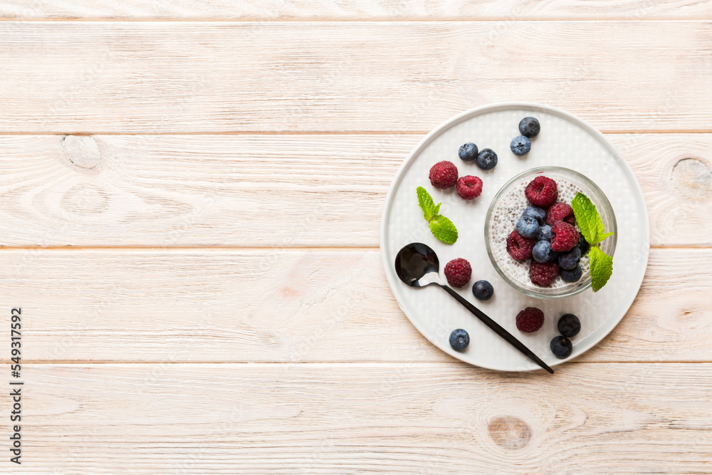 Healthy breakfast or morning with chia seeds vanilla pudding raspberry and blueberry berries on table background, vegetarian food, diet and health concept. Chia pudding with raspberry and blueberry Healthy breakfast or morning with chia seeds vanilla pudding raspberry and blueberry berries on table background, vegetarian food, diet and health concept. Chia pudding with raspberry and blueberry