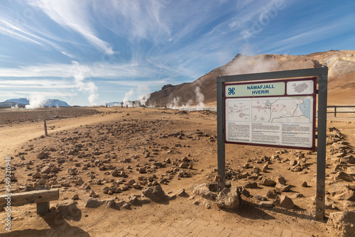 Namafjall is Iceland popular geothermal area with a unique landscape of steaming pools and mudpots. Sign post is in Icelandic and English language. photo