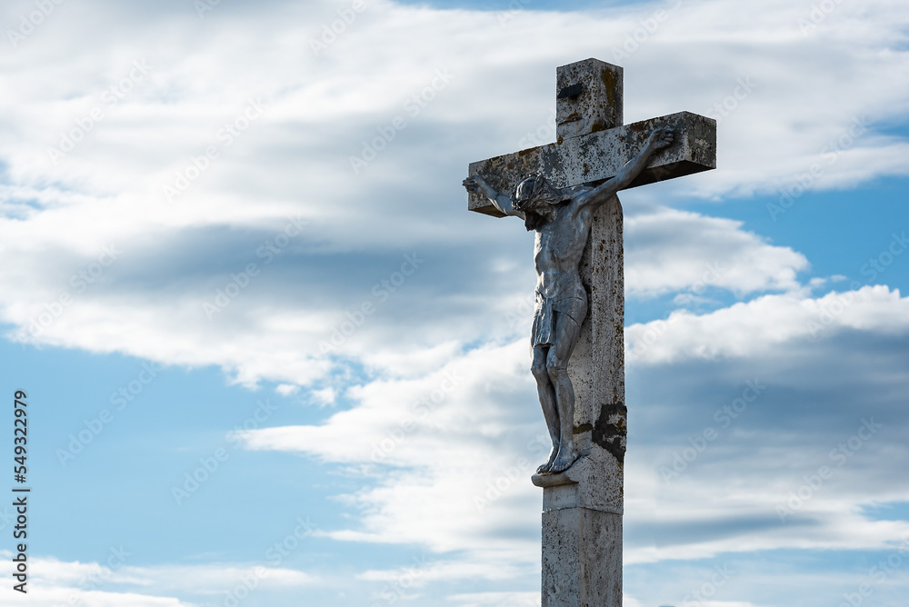 Crucifix and blue cloudy sky in the background Crucifix and blue cloudy sky in the background